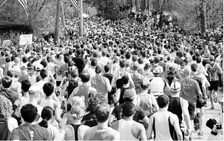  ??  ?? ARRIBA, parte de los 23,326 corredores que se inscribier­on en la carrera. A la izquierda, algunos de ellos se enteran del atentado en el área de Kenmore Square.