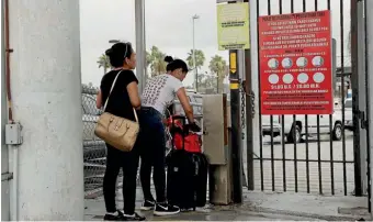  ?? AP ?? Guatemalan sisters and asylum seekers Josselin, 20, and Jennifer Garcia, 24, try to enter the United States from Matamoros, Mexico yesterday. US President Donald Trump has ended forced separation­s of migrant families at the border after an outcry.