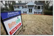  ?? AP file photo ?? A sign stands in front of a house in Walpole, Mass., last month. Sales of existing U.S. homes rose in February, the National Associatio­n of Realtors said Wednesday.