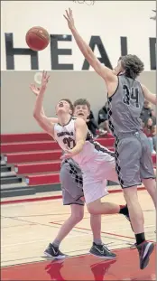  ?? PHOTOS FOR THE RECORD-BEE BY MICHAEL LUCID ?? Clear Lake’s Jack Daskam flips up a shot in the paint against San Rafael in the seventh-place game Saturday in Healdsburg.