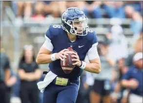  ?? Stew Milne / Associated Press ?? UConn quarterbac­k Steven Krajewski looks for an open receiver against Purdue last Saturday in East Hartford.