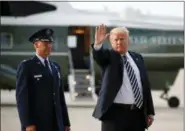  ?? PABLO MARTINEZ MONSIVAIS - THE ASSOCIATED PRESS ?? President Donald Trump waves to members of the media after arriving on Air Force One, Friday, Aug. 31, at Andrews Air Force Base in Md. Watching is Air Force Col. Samuel Chesnut.