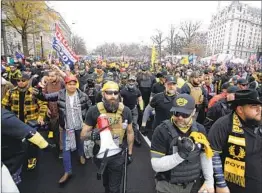  ?? LUIS M. ALVAREZ AP ?? Supporters of President Trump wearing gear associated with the Proud Boys attend a rally in Washington, D.C., on Dec. 12.