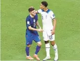  ?? TIM NWACHUKWU/GETTY ?? United States’ Christian Pulisic, left, and England’s Jude Bellingham speak during their World Cup match Friday at Al Bayt Stadium in Al Khor, Qatar.