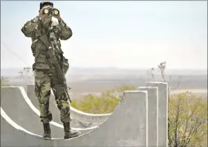  ?? AP PHOTO ?? In this June 12, 2006, file photo, Army National Guard Spc. Gustavo Gutierrez, 23, of Las Cruces, N.M., scans the U.S./Mexico border from the top of Radar Hill, near Columbus, N.M. In his threat Tuesday, April 3, 2018, to use the military on the...