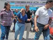  ?? CRISTIAN HERNANDEZ EPA/Shuttersto­ck ?? RELATIVES react to the news in Caracas. The stampede happened after a tear gas device exploded during a brawl. Some said victims couldn’t get out.