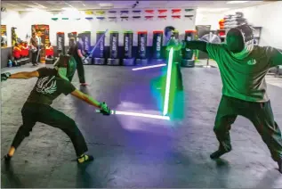  ?? Cory Rubin/The Signal ?? Students of Light Force Academy learn martial arts sword fighting with a Star Wars flair at Iron Fist Martial Arts Academy in Newhall.
