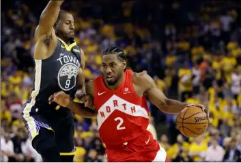  ?? AP PHOTO/BEN MARGOT ?? in this June 13 file photo, toronto Raptors forward Kawhi Leonard (2) drives against Golden State Warriors forward Andre iguodala (9) during the first half of Game 6 of basketball’s nBA Finals in Oakland, Calif.