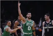  ?? CHARLES KRUPA — THE ASSOCIATED PRESS ?? Boston Celtics forward Jayson Tatum (0) celebrates after a basket against the Milwaukee Bucks in the first half of Game 2of an Eastern Conference semifinal in the playoffs Tuesday in Boston.