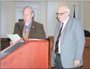  ?? Diane Wagner / RN-T ?? Retired Superior Court judge Larry Salmon (left) eyes the proclamati­on just read by County Commission­er Larry Maxey naming March 29, 2018, as Larry Salmon Day in Rome and Floyd County in honor of Salmon’s public service as solicitor, district attorney...