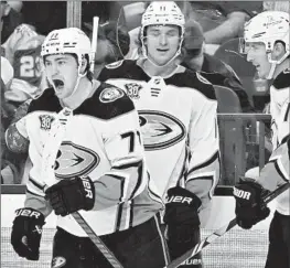  ?? David Becker Associated Press ?? THE DUCKS’ Frank Vatrano, left, celebrates the second of his three goals Thursday night with Trevor Zegras (11) and Ryan Strome during the third period.