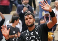  ?? MICHEL EULER — THE ASSOCIATED PRESS ?? France’s Jo-wilfried Tsonga has a mark on his forehead after kissing the clay after losing to Norway’s Casper Ruud in a first round match of the French Open at the Roland Garros stadium on Tuesday in Paris.