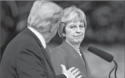  ?? AP PHOTO ?? Britain’s Prime Minister Theresa May and U.S. President Donald Trump answer questions during a joint press conference following their meeting at Chequers, in Buckingham­shire, England, Friday.