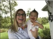  ?? JULIE CARR SMYTH — THE ASSOCIATED PRESS ?? Kelly Kuhns holds her son, Oliver, in Plain City, Ohio. Kuhns is advocating for an Ohio bill that would ban abortions based on the type of pre-natal Down syndrome diagnosis she received for her son, Oliver.