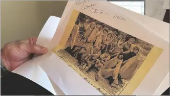  ?? AP PHOTO/SUSAN MONTOYA BRYAN ?? In this 2021 photo, adjunct history professor and research associate Larry Larrichio holds a copy of a late 19th century photograph of pupils at an Indigenous boarding school in Santa Fe during an interview in Albuquerqu­e, N.M.