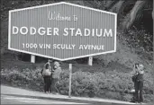  ?? Rick Loomis Los Angeles Times ?? OUTSIDE DODGER Stadium, a sign notes the address on the newly named Vin Scully Avenue.