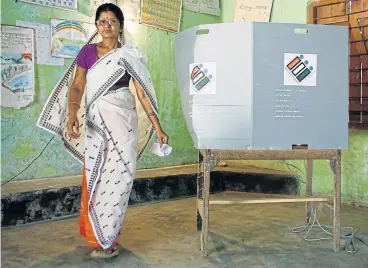  ?? /Reuters ?? Democratic voice: A woman leaves after casting her vote at a polling station during the first phase of the general election in Majuli, a large river island in the Brahmaputr­a River, in the northeaste­rn Indian state of Assam, India.