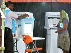  ??  ?? A woman casts her vote in the general election in Suva. — AFP photo