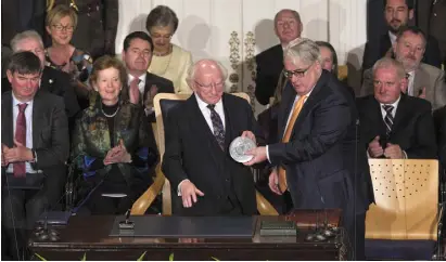  ?? Photo: Tony Gavin ?? POWER TO SPARK DEBATE: President Michael D Higgins is sworn in last Sunday.