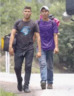  ??  ?? Venezuelan migrants walk along the road from Cucuta to Pamplona, in Norte de Santander Department, Colombia. — AFP photos