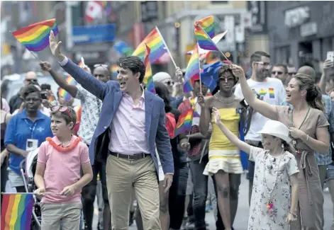  ?? MARK BLINCH /THE CANADIAN PRESS ?? Prime Minister Justin Trudeau, his wife Sophie Gregoire Trudeau and their children Ella-Grace and Xavier walk in the Pride parade in Toronto, Sunday.