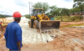  ?? — Getty Images ?? A digger at work on the road at Arcadia’s mine in Zimbabwe last year. The landlocked country’s lithium would need to cross a border to even begin to access the global market.