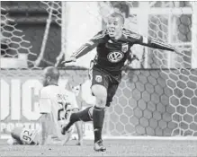  ?? ASSOCIATED PRESS FILE PHOTO ?? D.C. United's Charlie Davies, right, reacts after scoring a goal against the Columbus Crew's Julius James (26) during the second half of a Major League Soccer game in Washington in March 2011.