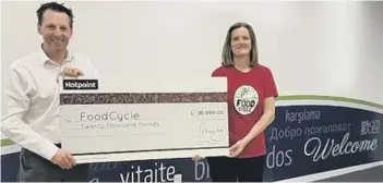  ??  ?? Ian Moverley, of Whirlpool UK Appliances, presents the cheque to Mary McGrath, CEO of Food Cycle.