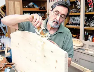  ??  ?? Hands-on: Furniture maker Paul Sellers hard at work in his workshop