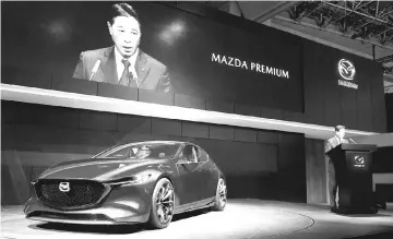  ?? — AFP photo ?? Masamichi Kogai, president of Mazda introduces its concept car “Kai” during the Tokyo Motor Show.