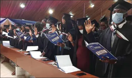  ?? ?? Medical graduates of the Benjamin Carson College of Health and Medical Sciences, Babcock University, Ilishan Remo, Ogun State, taking their oath of allegiance into the Medical and Dental Council Nigeria ( MDCN) at the institutio­n’s sixth induction ceremony recently