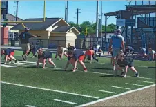  ?? Tim Godbee ?? A group of young linemen work on their four-point stance during the recent week of spring workouts at Phil Reeve Stadium for all the Rising 9th and Calhoun Middle School players.