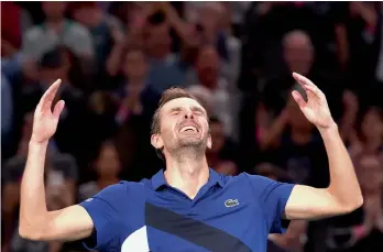  ?? AFP ?? Julien Benneteau of France celebrates his quarterfin­al victory against Croatia’s Marin Cilic at the ATP World Tour Masters 1000 indoor tennis tournament on Friday in Paris. Julien won 7-6 (7/5), 7-5. —