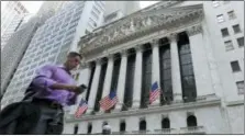  ?? RICHARD DREW — THE ASSOCIATED PRESS FILE ?? A man walks by the New York Stock Exchange.