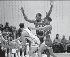  ?? SCOTT APPLEWHITE - ASSOCIATED PRESS FILE ?? University of the District of Columbia’s Cedric Caldwell (13) tries to pass around Cheyney State’s Keith Johnson (12) and Jerry Moore during first half action in the South Atlantic Division quarterfin­als of the NVAA Division II Playoffs on March 15,...