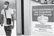  ?? Nam Y. Huh / Associated Press ?? A department store in Rosemont, Ill., displays a sign stating that masks are required for shoppers.