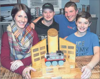  ?? KEVIN ADSHADE/THE NEWS ?? Kaitlin Graham and Jax Graham are shown with the Cancer Sucks Cup trophy, while in back are Isaac Koehoorn, left, and Drew Graham.