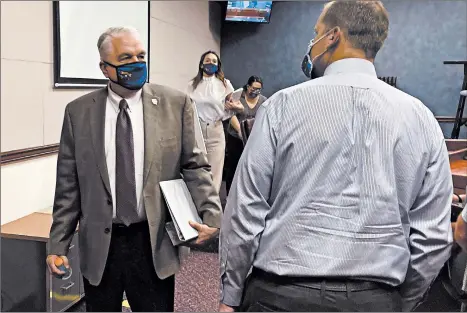  ?? SAMUEL METZ/AP ?? Nevada Gov. Steve Sisolak exits a news conference Wednesday after announcing Nevada would join California, Washington and North Carolina in requiring masks in public.