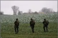  ?? (AP/Vasilisa Stepanenko) ?? Polish soldiers search for missile pieces Thursday in the field near where a missile struck Tuesday in the village of Przewodow near the border with Ukraine.