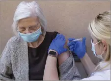  ?? ASSOCIATED PRESS ?? Poydras Home resident Martha Treen gets the Moderna vaccine from CVS pharmacist Catherine Ramzy at the home on Magazine Street in New Orleans on Wednesday. Mrs. Treen was hospitaliz­ed for several months with COVID-19. Her husband was John Treen, who ran against David Duke. The two were hospitaliz­ed in the same room and he died in April.