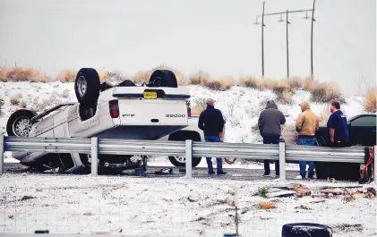  ?? ROBERTO E. ROSALES/JOURNAL ?? A vehicle rolled over on northbound Interstate 25 just south of Rio Bravo Saturday. The storm hit the metro area Saturday afternoon and meteorolog­ists warned that it was likely to worsen overnight.