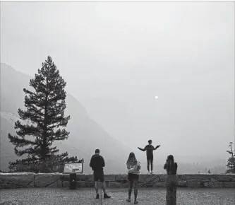  ?? NOAH BERGER THE ASSOCIATED PRESS ?? Hannah Whyatt poses for a photo as smoke from the Ferguson Fire fills Yosemite Valley, in California’s Yosemite National Park, Wednesday.