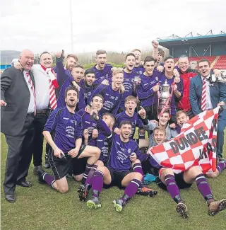  ??  ?? Dundee Argyle celebratin­g with the Scottish Sunday Trophy last season — they are on course to retain the title after reaching this season’s quarter-final.