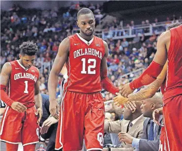  ?? [PHOTO BY SARAH PHIPPS, THE OKLAHOMAN] ?? Oklahoma’s Rashard Odomes (1) and Khadeem Lattin (12) exit the game in the final minute during the Big 12 Tournament against TCU at the Sprint Center in Kansas City, Mo.