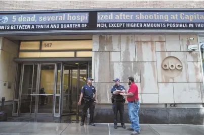  ?? AP PHOTOS ?? ‘SO MUCH VITRIOL’: Police officers stand guard outside the ABC studios, above, and The New York Times building, below, in light of a shooting at a Maryland newspaper yesterday.