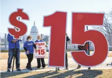  ?? J. SCOTT APPLEWHITE/AP ?? Activists appeal for a $15 minimum wage last week near the U.S. Capitol. The House has passed a $1.9 trillion COVID-19 relief bill that includes a provision that would gradually hike the federal minimum wage to $15 an hour.