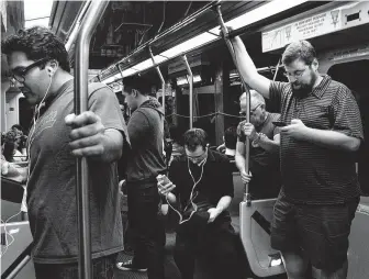  ?? Liz Hafalia / San Francisco Chronicle file ?? Passengers use technology on their way home in San Francisco. Technology giants like Facebook, Google and Amazon ask us to trust them with ever more sensitive aspects of our lives.