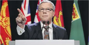  ?? PATRICK DOYLE / THE CANADIAN PRESS ?? Saskatchew­an premier Brad Wall speaks Friday before the first ministers meeting. Wall says the national climate plan will hammer Saskatchew­an industry. “We’re not signing.”