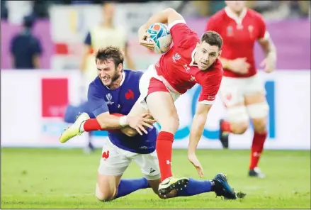  ??  ?? Wales’ Tomos Williams is tackled by France’s Maxime Medard during the Rugby World Cup quarter-final match at Oita Stadium in Oita, Japan on Oct 20.
(AP)