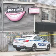  ?? ANDREW VAUGHAN / THE CANADIAN PRESS FILES ?? A police car sits outside the Gabriel Wortman's Atlantic
Denture Clinic in Dartmouth, N.S., on April 20, 2020.